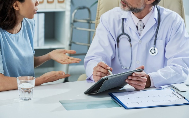 doctor-pointing-digital-tablet-screen-while-explaining-something-patient-1ca289a6-a610c5.jpg