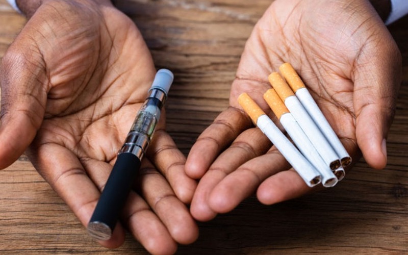 hands-holding-a-vape-pen-and-cigarettes-8fe77f.jpg